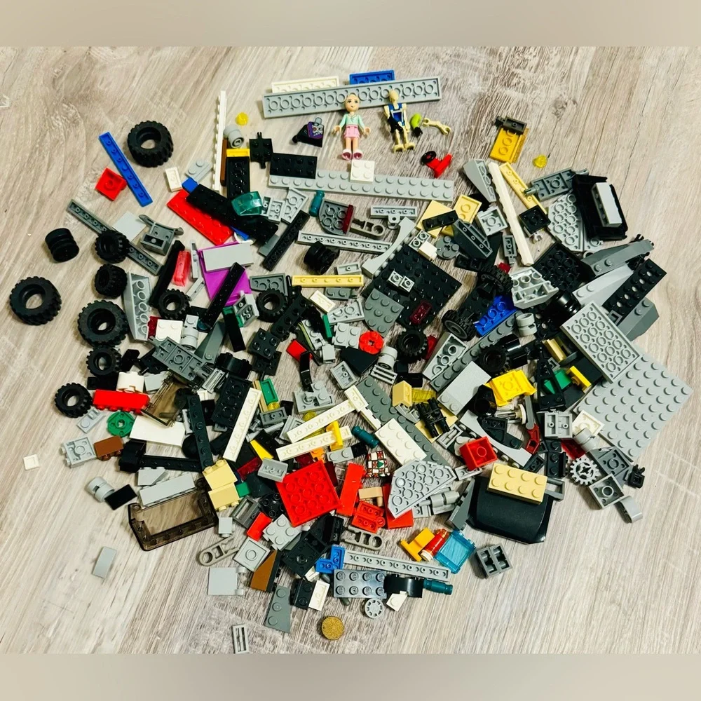 0.697 lbs. Net weight of small Lego bricks. Various parts and pieces. There are
